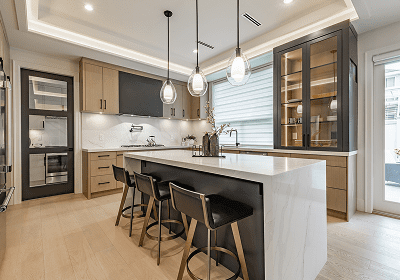 Modern kitchen with island and pendant lights.